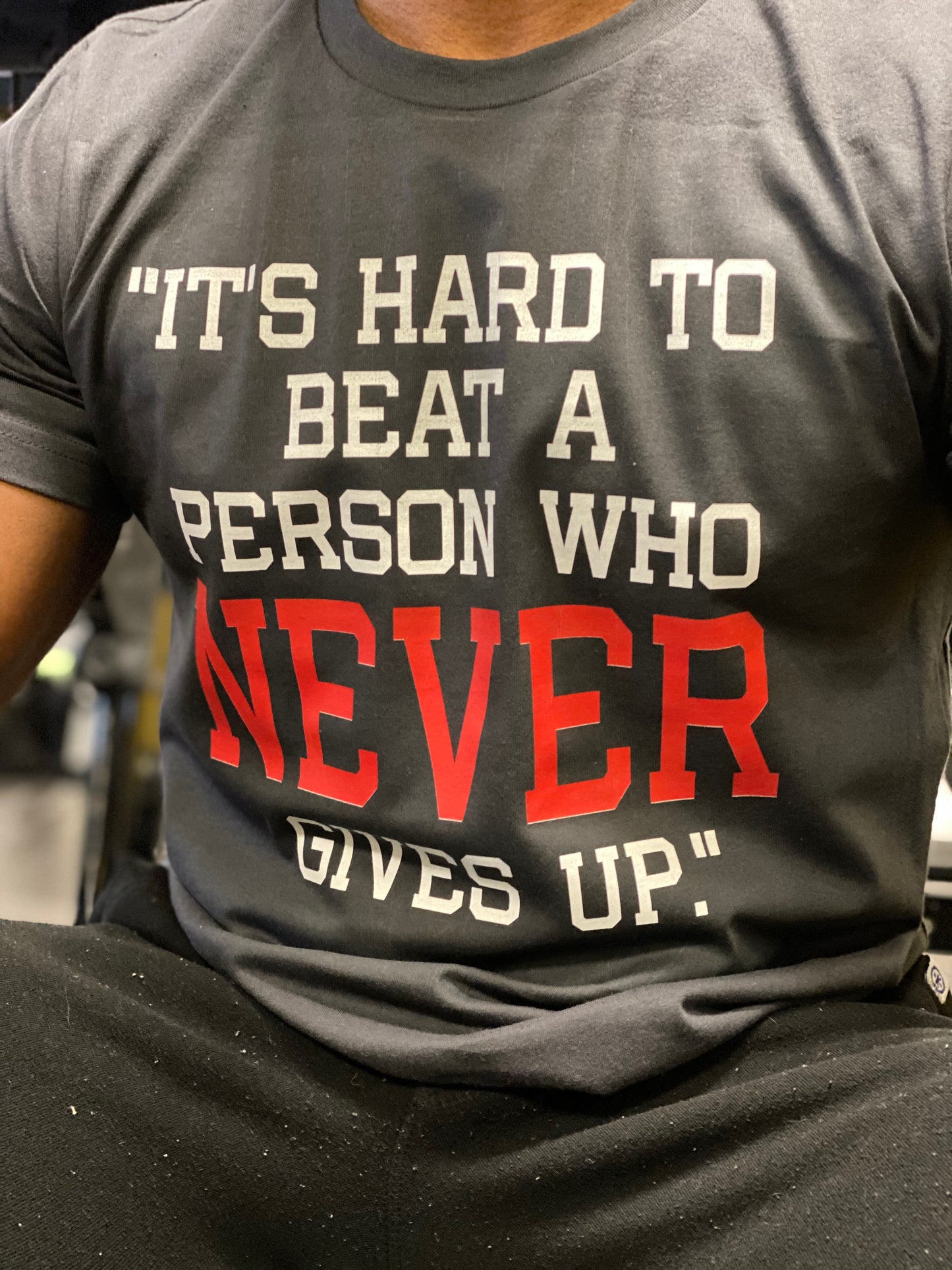 Its Hard To Beat A person Who Never Give Up T-shirts